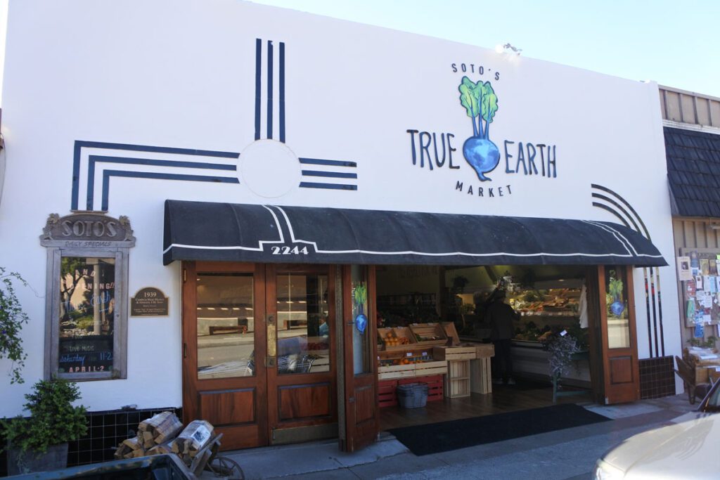 Store front with black awning and logo "Sotos".