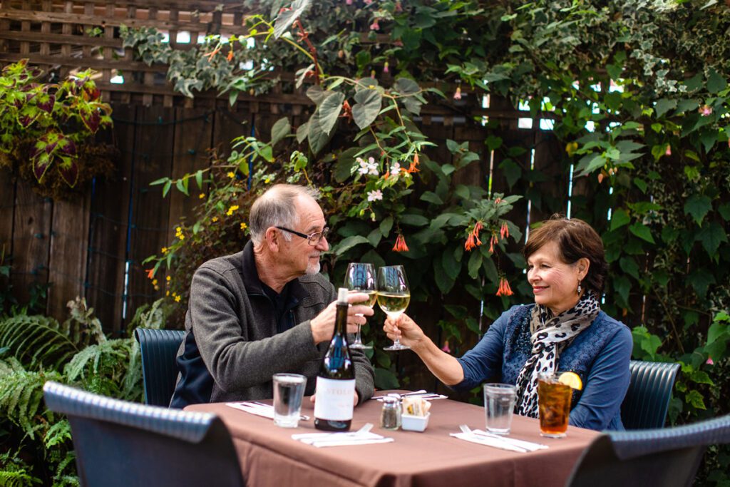 A couple shares a intimate dinner on one of Cambria's many patio restaurants.