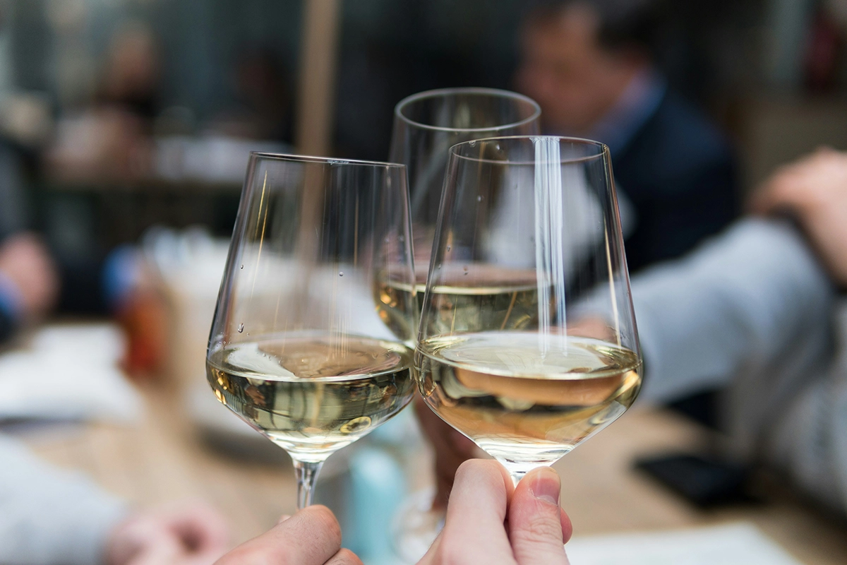 Three glasses of wine held together for a cheers.